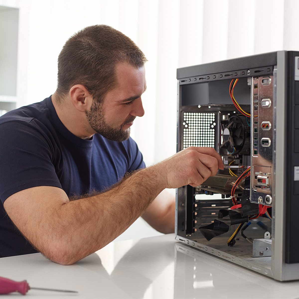computer support tech working on a tower