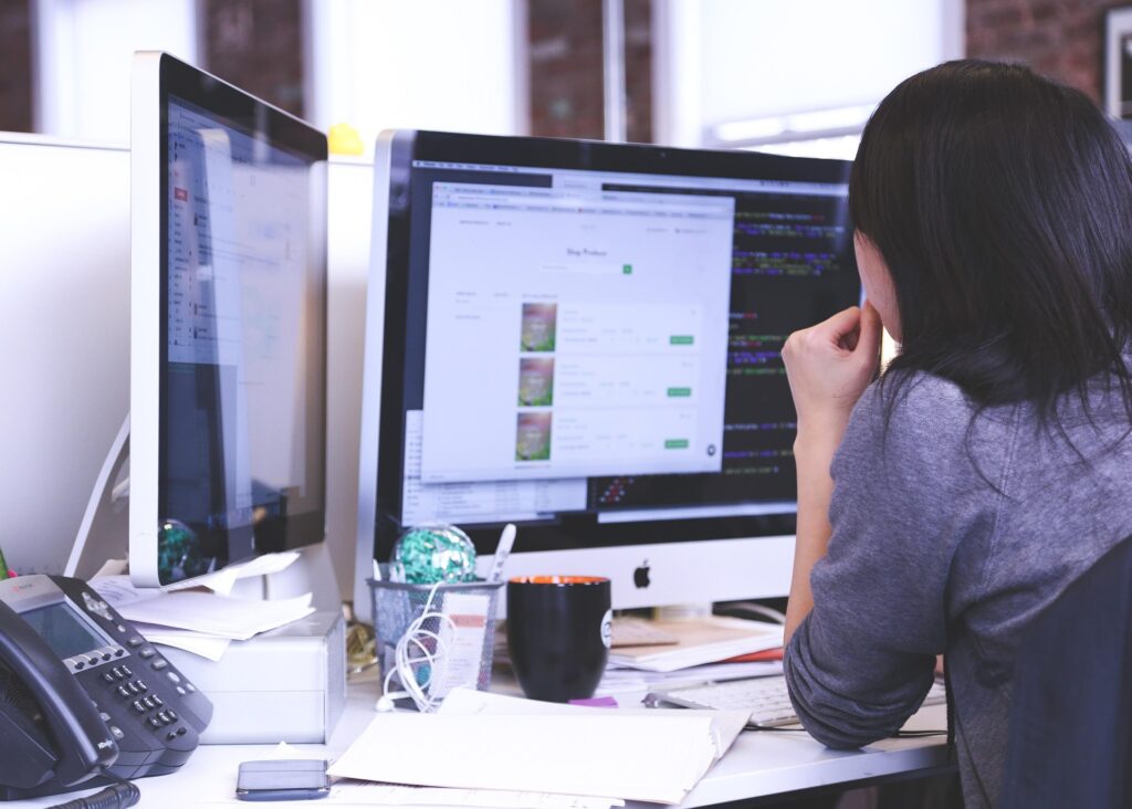 Woman on her desktop computer at work