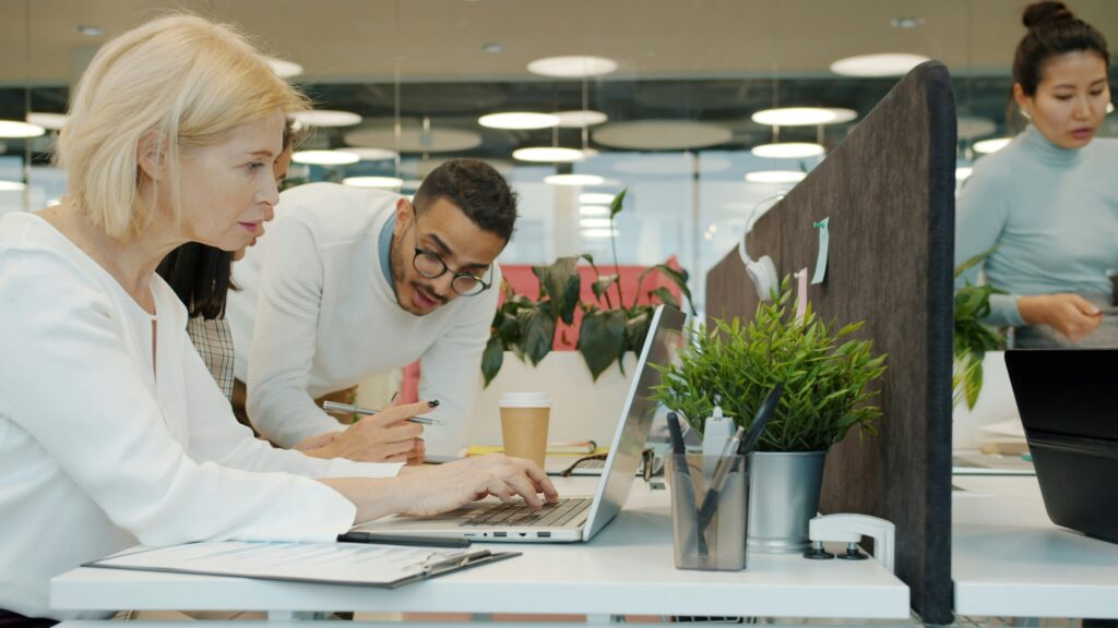 Woman and man troubleshooting their business computer