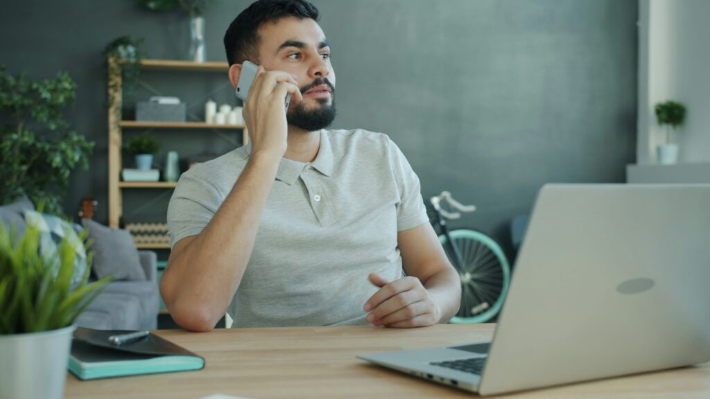 Man calling his IT support for his business laptop