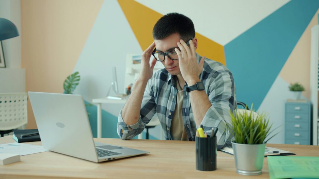 man frustrated with his laptop